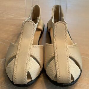 Size 7 flat sandals with elastic sides new without box or tags, great condition
